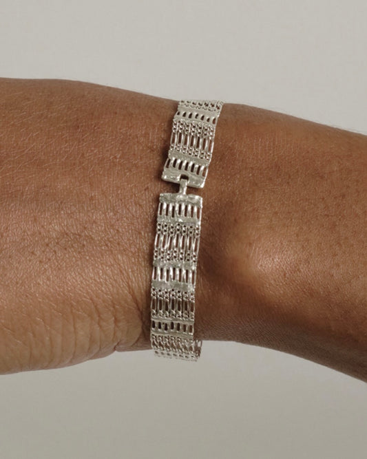 Image of a sterling silver chain bracelet on a person's wrist.