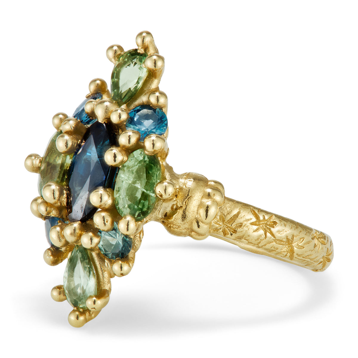 A yellow gold ring in a north-south kite shape with a mix of blue and green sapphires.