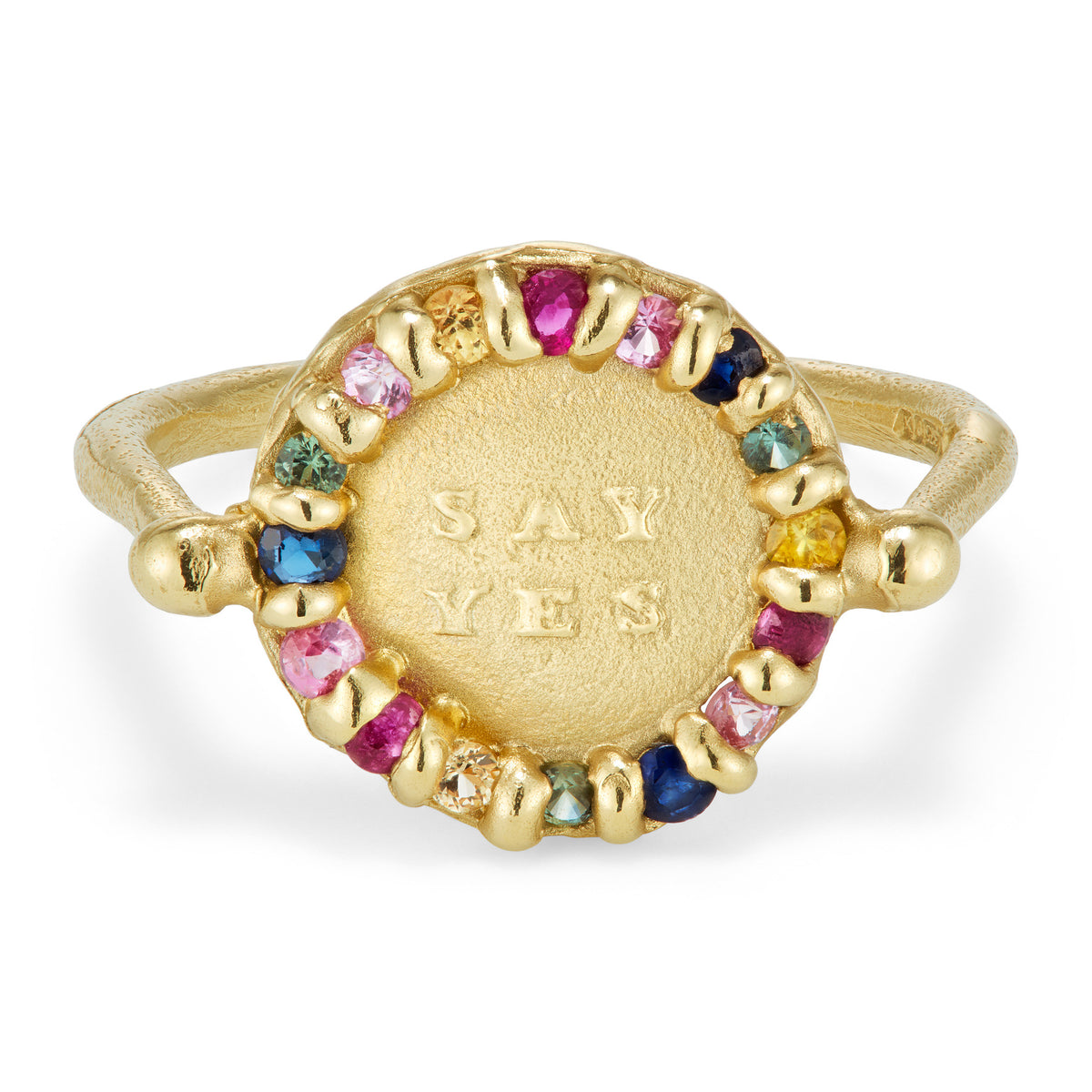 A yellow gold ring with a ring of colorful sapphires surrounding the message 'Say Yes'.