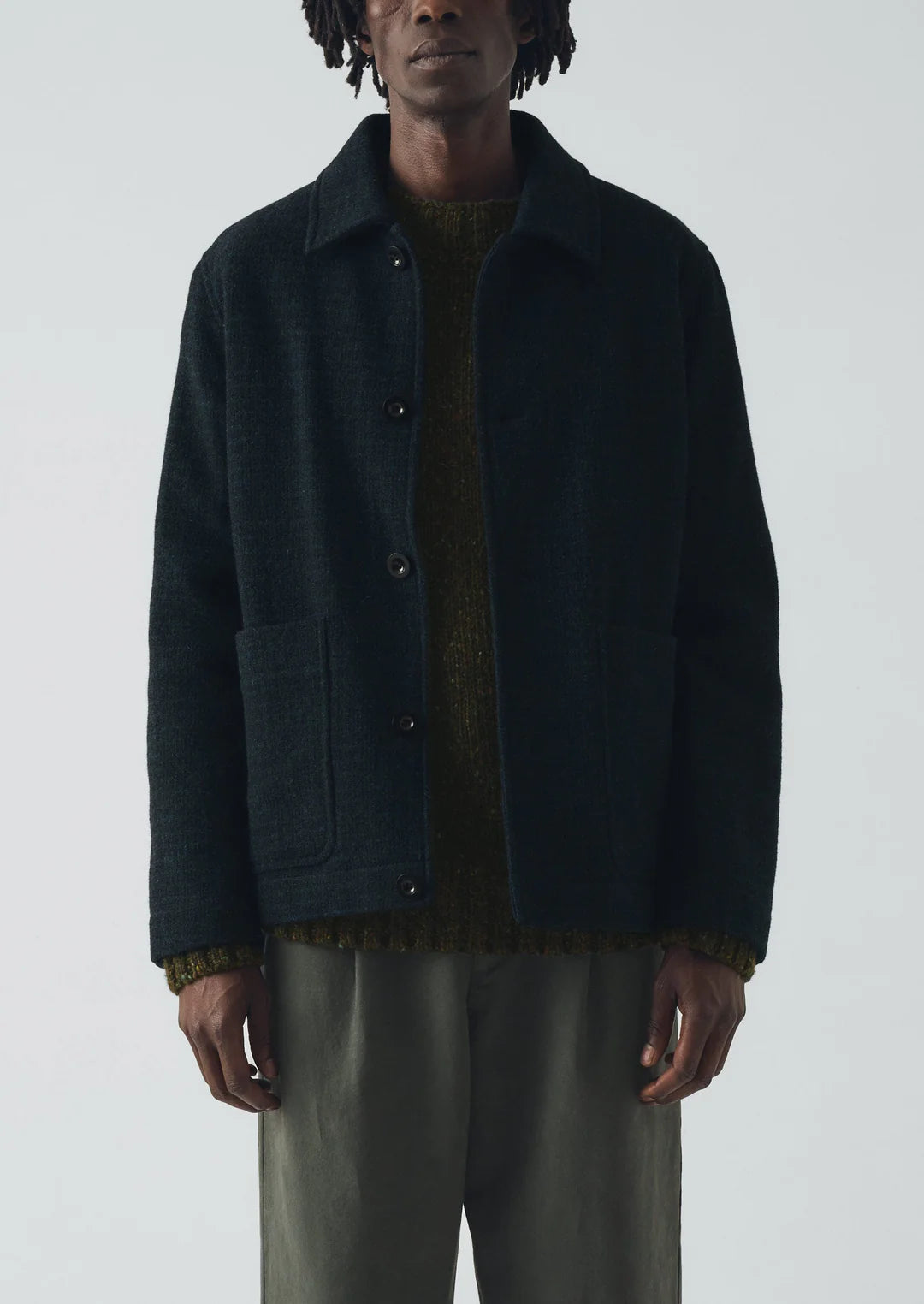 Person wearing a dark blue jacket on a white background