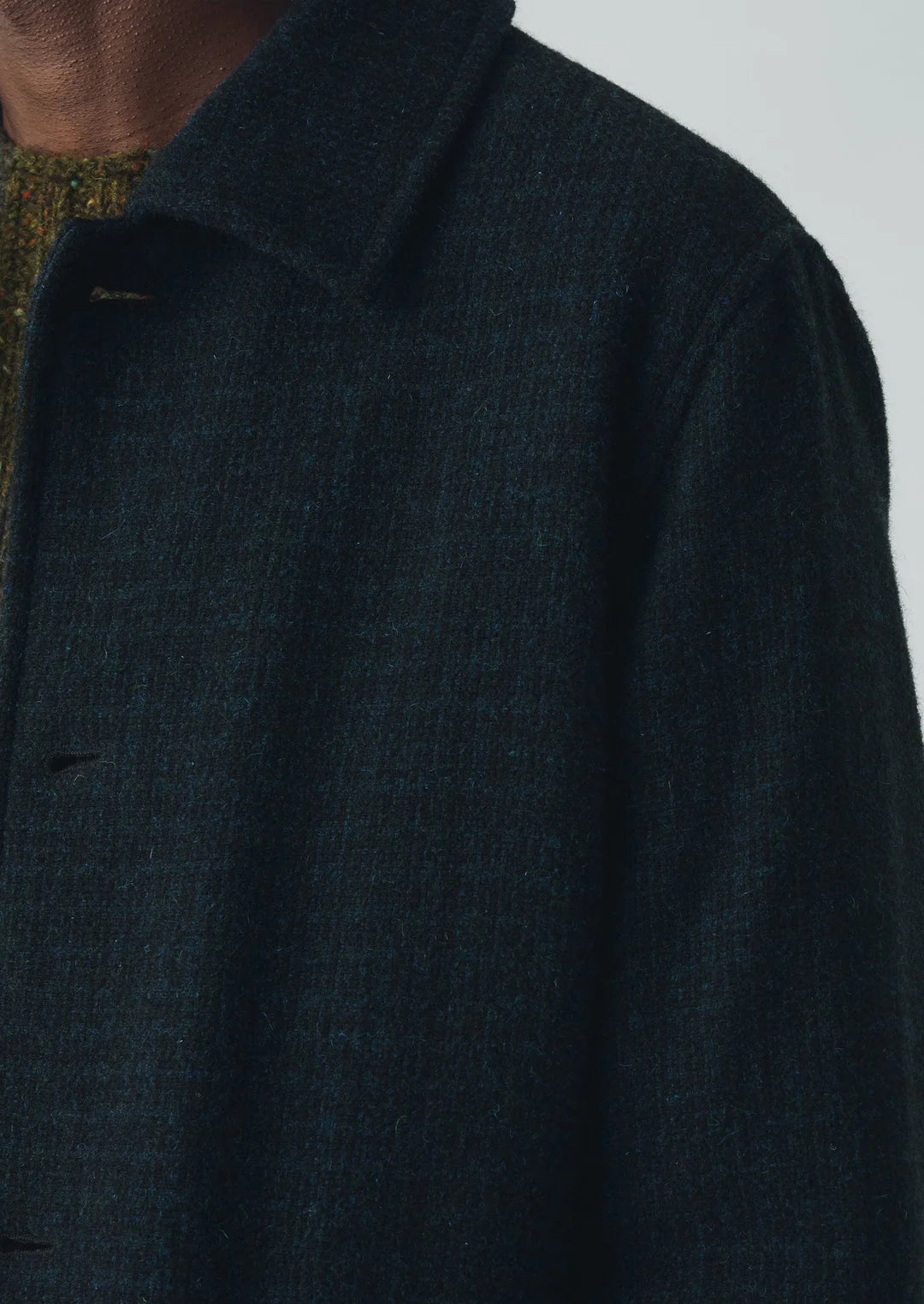 Close-up of a dark blue coat with a blurred background