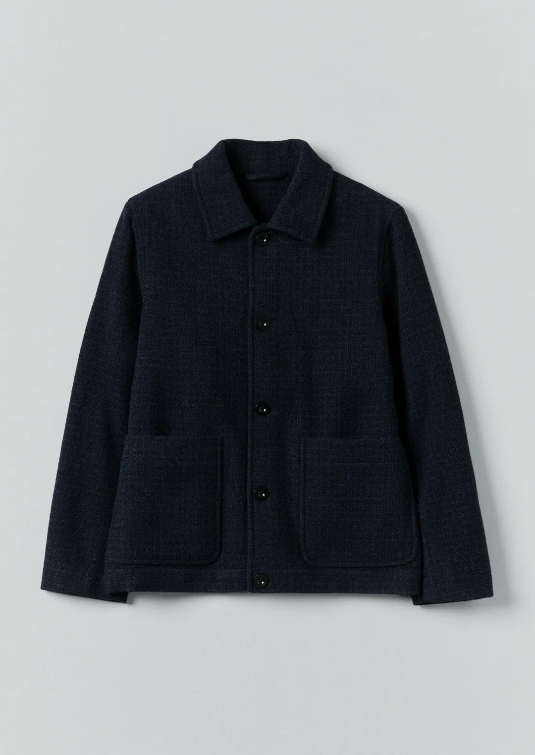 Black jacket with button details on a light gray background