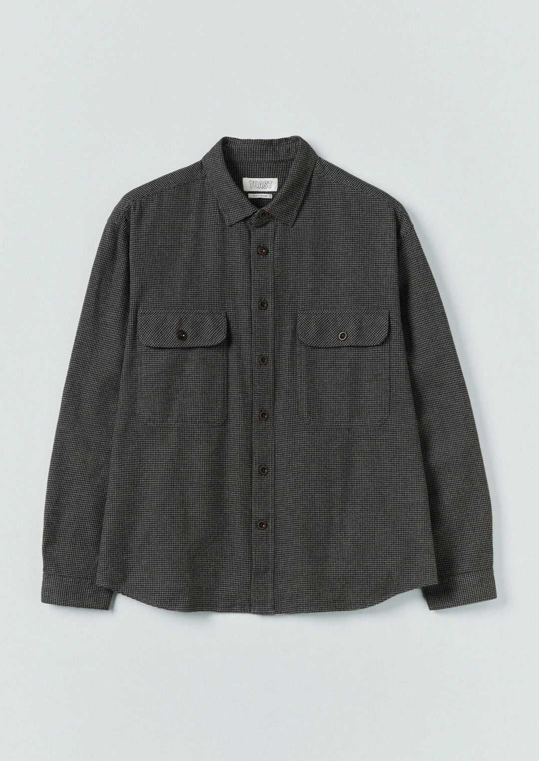 Dark gray shirt with two front pockets on a light gray background