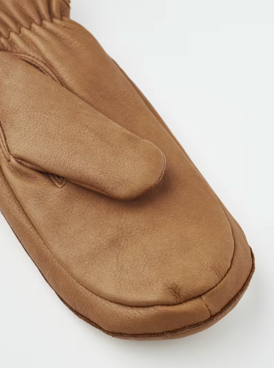 Brown leather mitten on a white background