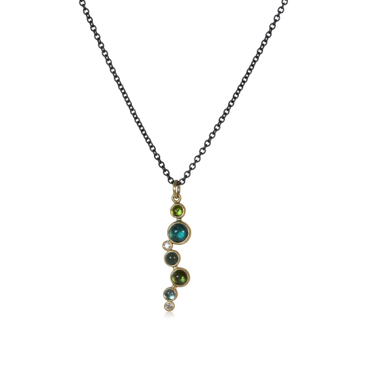 A pendant with blue and green round tourmalines and white diamonds cascading down in a line all set in gold on an oxidized sterling silver chain.