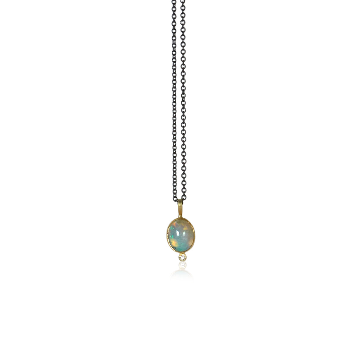 Opal cabochon pendant with a tiny diamond highlight at the bottom on an oxidized sterling silver chain