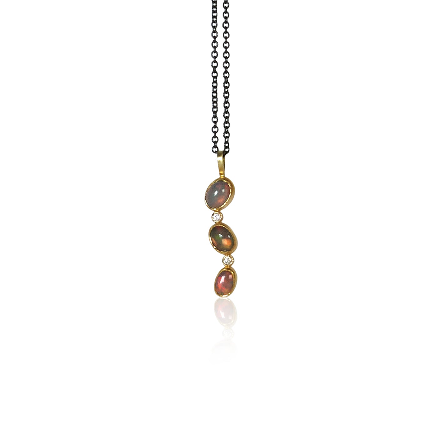 Three Ethiopian opals and two small white diamonds hang from an oxidized silver chain.