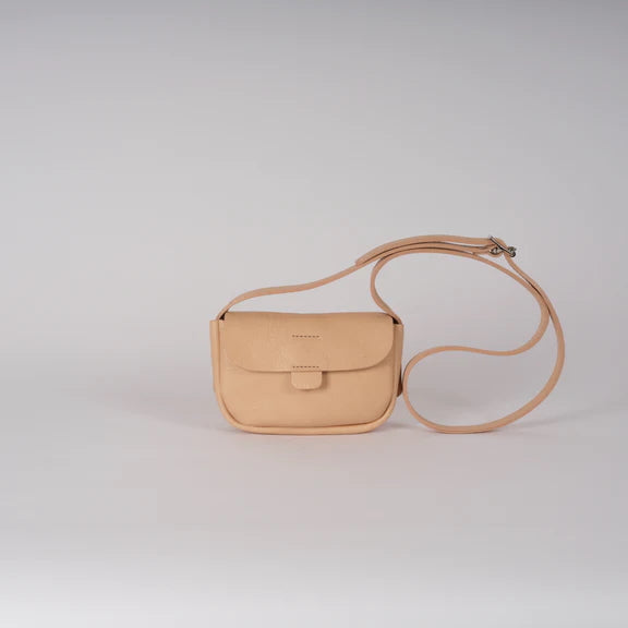 Picture, front of light brown handbag on plain grey background.