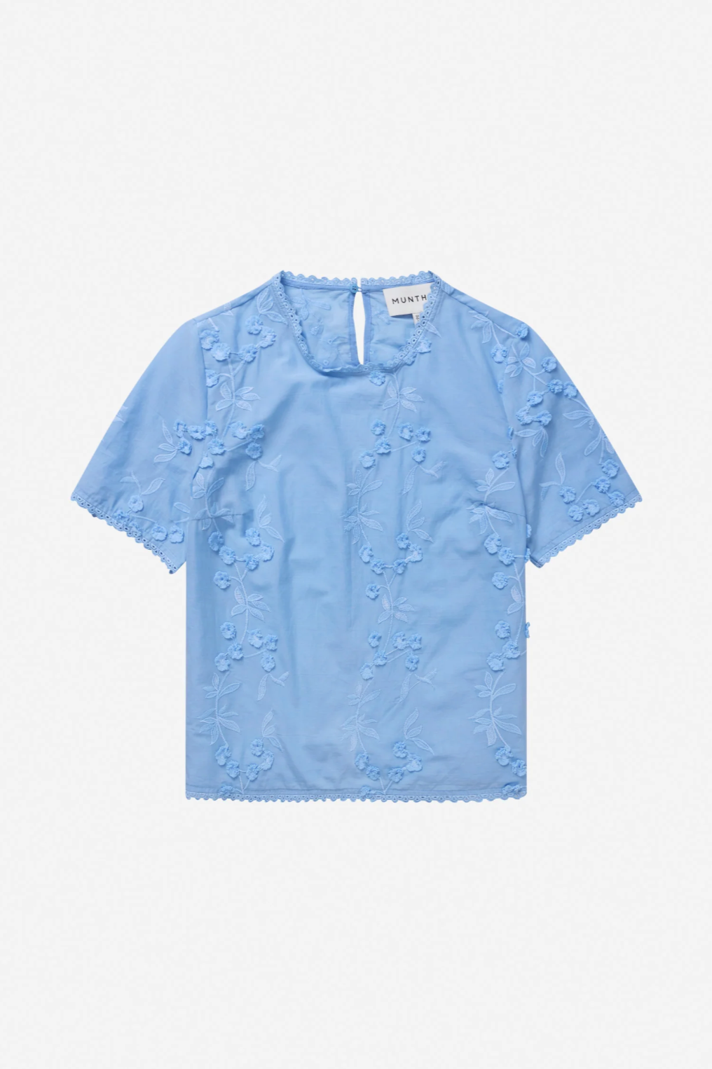 Image of short sleeve top with round neckline and floral applique.
