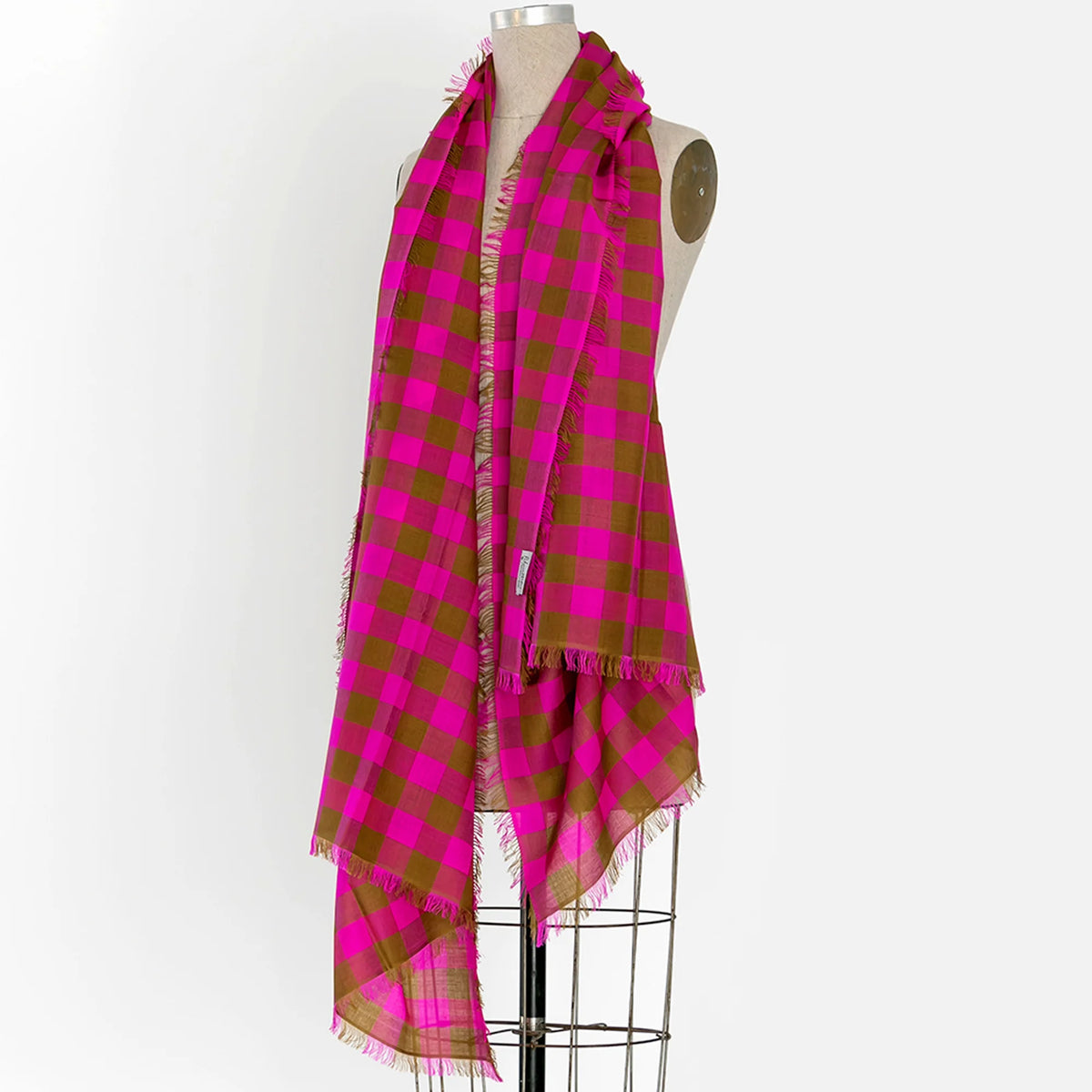 A pink and green checkered gingham scarf shown wrapped around a mannequin.