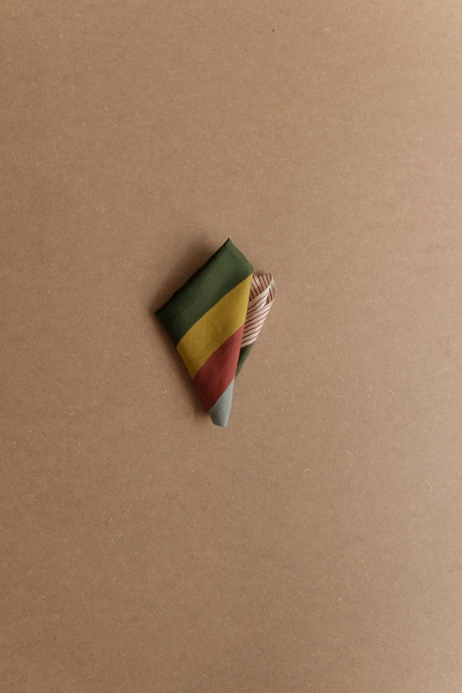 Picture of silk scarf with stripes folded into triangle shape.