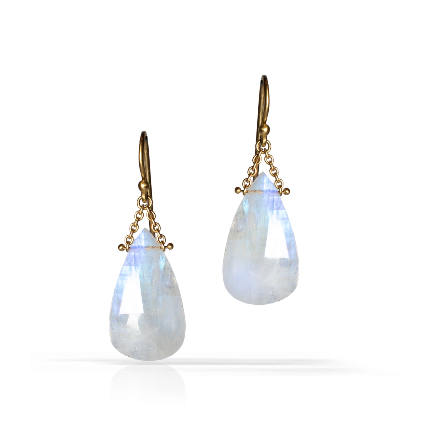 A pair of teardrop-shaped drop earrings featuring milky white to light blue iridescent stones suspended from antique gold-tone hooks and chains, shown on a clean white background.