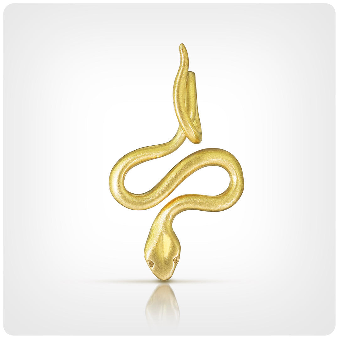 A gold snake pendant or earring charm with a polished finish, shown on a light gray background with a soft reflection underneath.