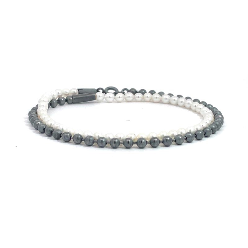 A double-strand beaded bracelet featuring white freshwater pearls and oxidized sterling silver, shown on a plain white background.