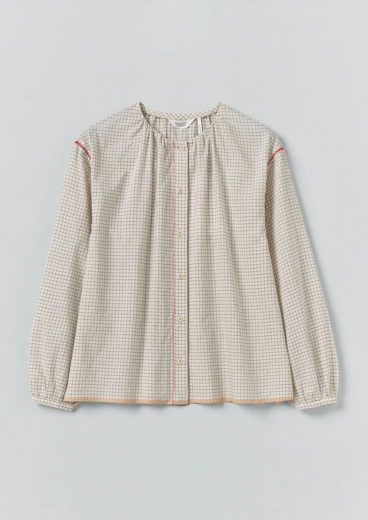 Checkered blouse with long sleeves on a light gray background