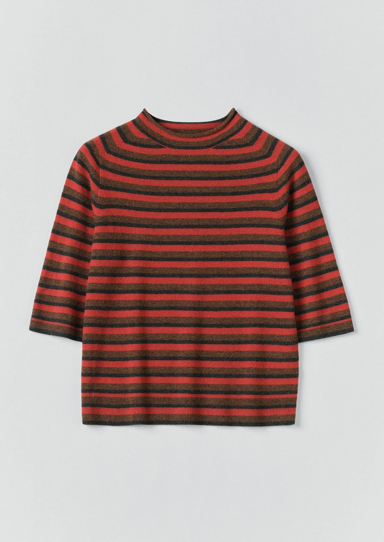 Red and black striped sweater on a light gray background