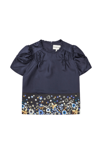 Navy blue short sleeve silk blouse with floral border at the waist.