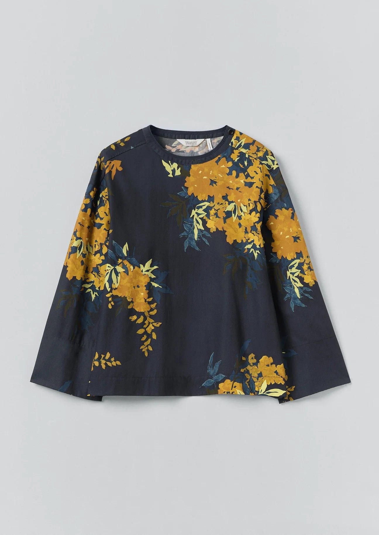 Navy blue long-sleeve top with yellow floral pattern on a light gray background