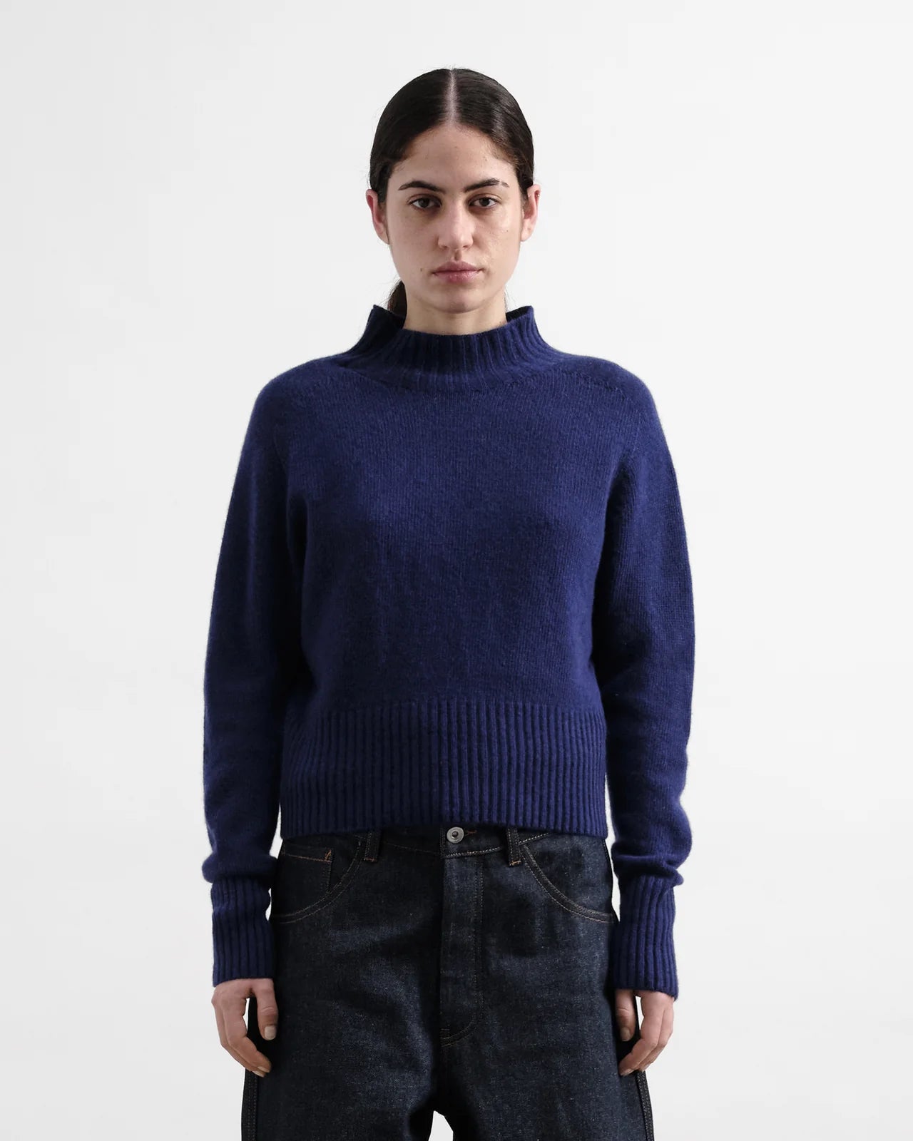 Person wearing a blue sweater on a white background