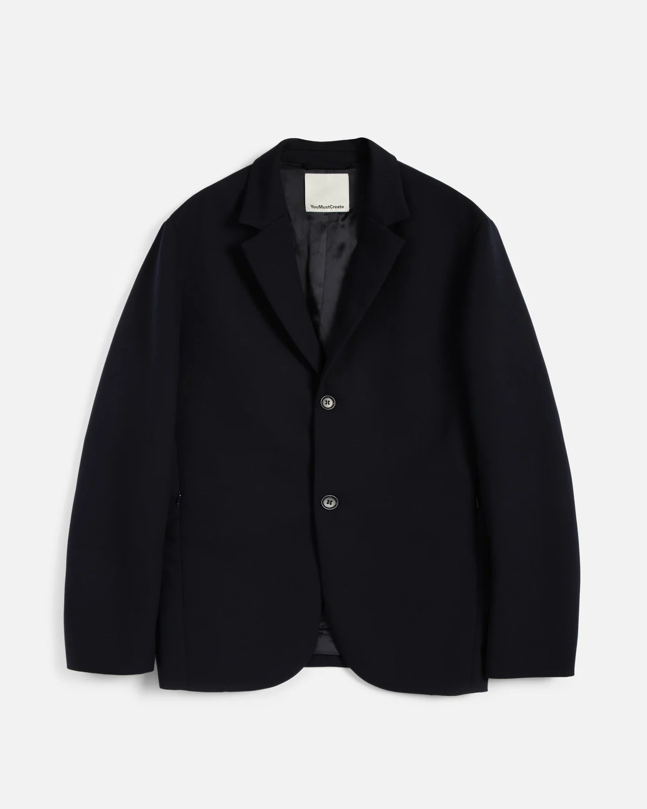 Navy blazer on a light gray background