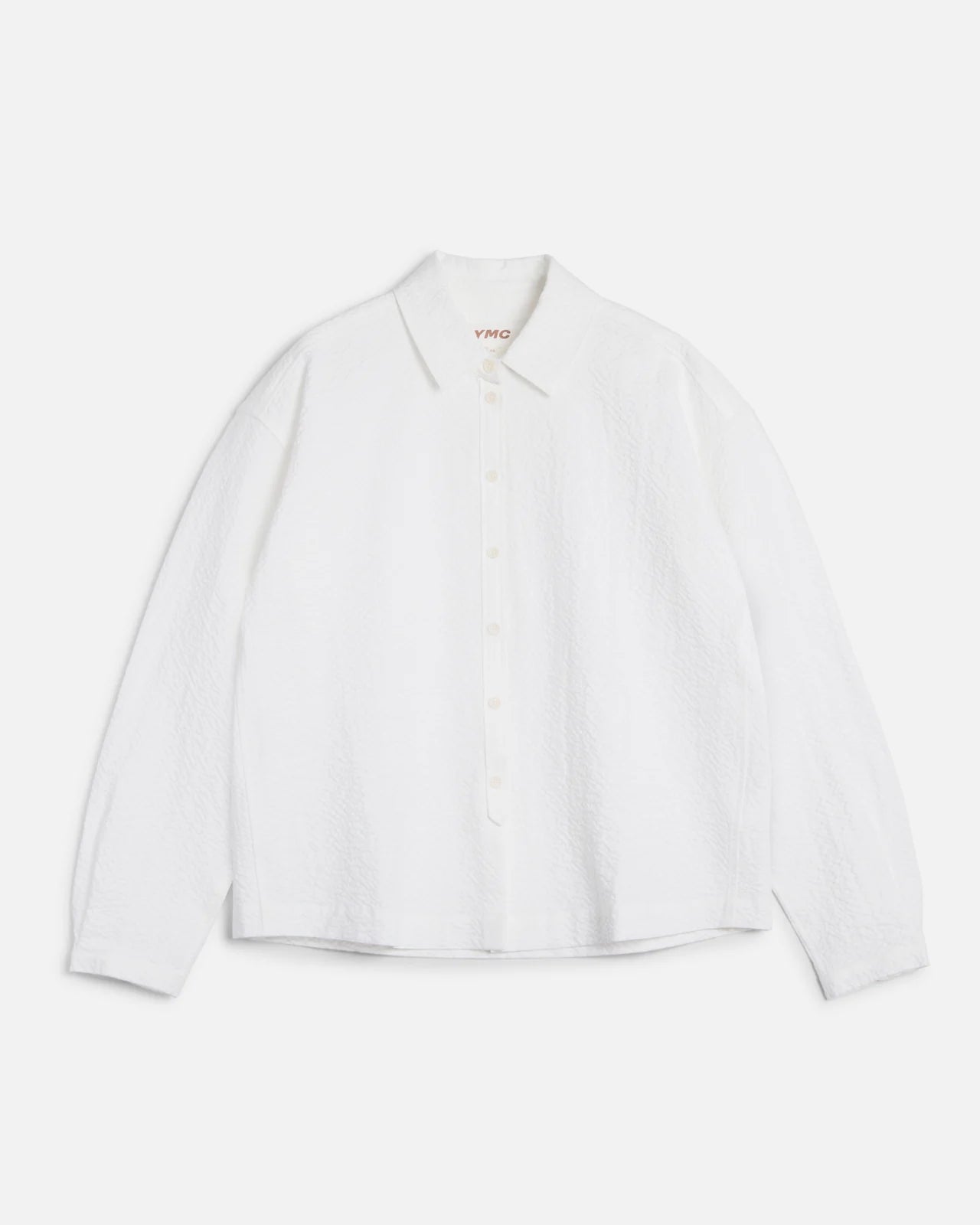 White blouse with a brand logo on a light gray background