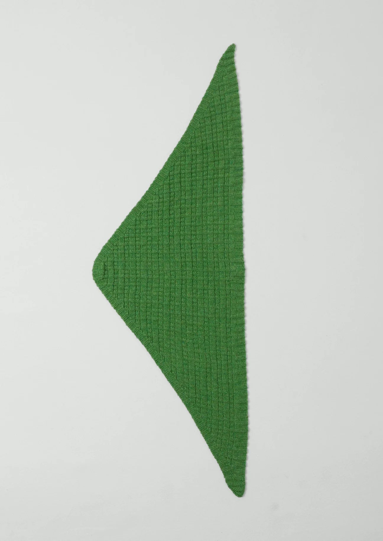 Green triangular fabric on a white background
