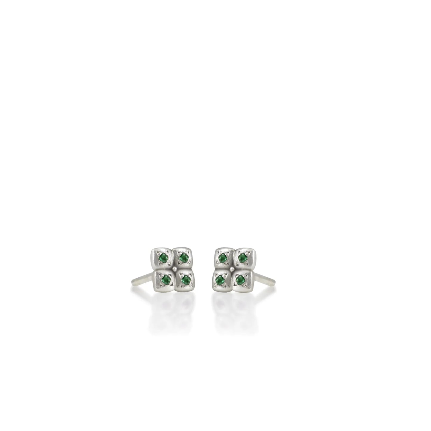 Pair of silver earrings with green gemstones on a white background