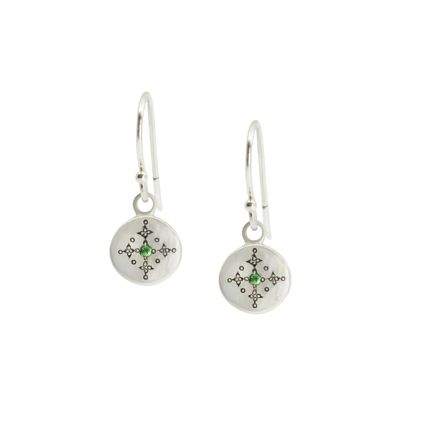 Silver earrings with circular designs and green gemstones on a white background