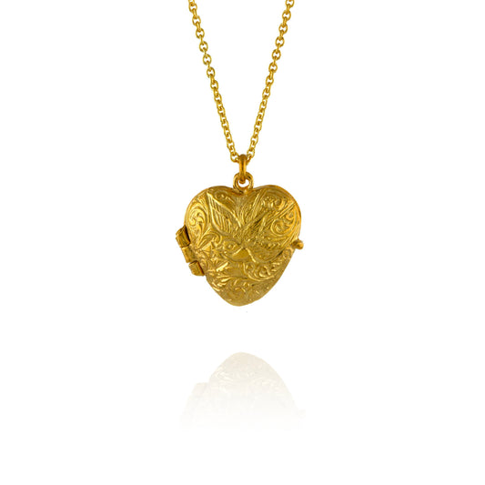 Gold heart-shaped locket on a chain against a white background