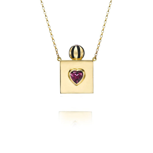 Gold necklace with a heart-shaped gemstone pendant on a white background