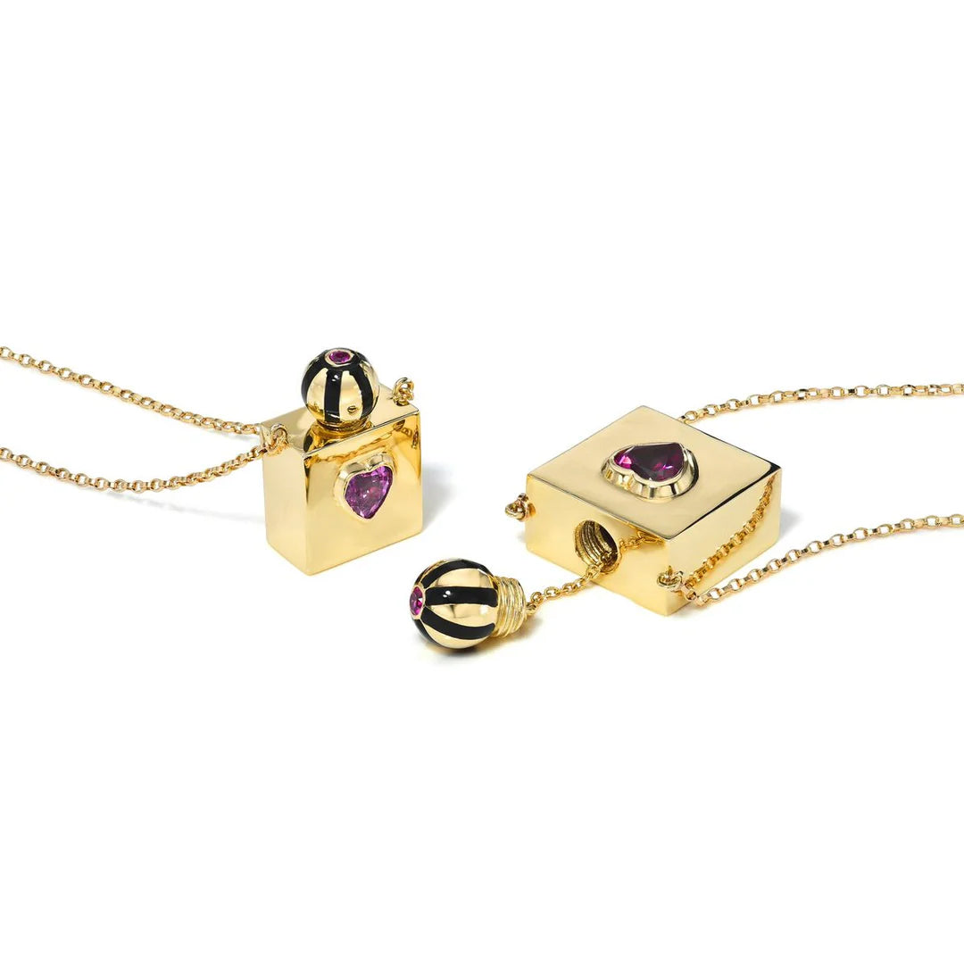Gold necklaces with heart-shaped gemstones on a white background