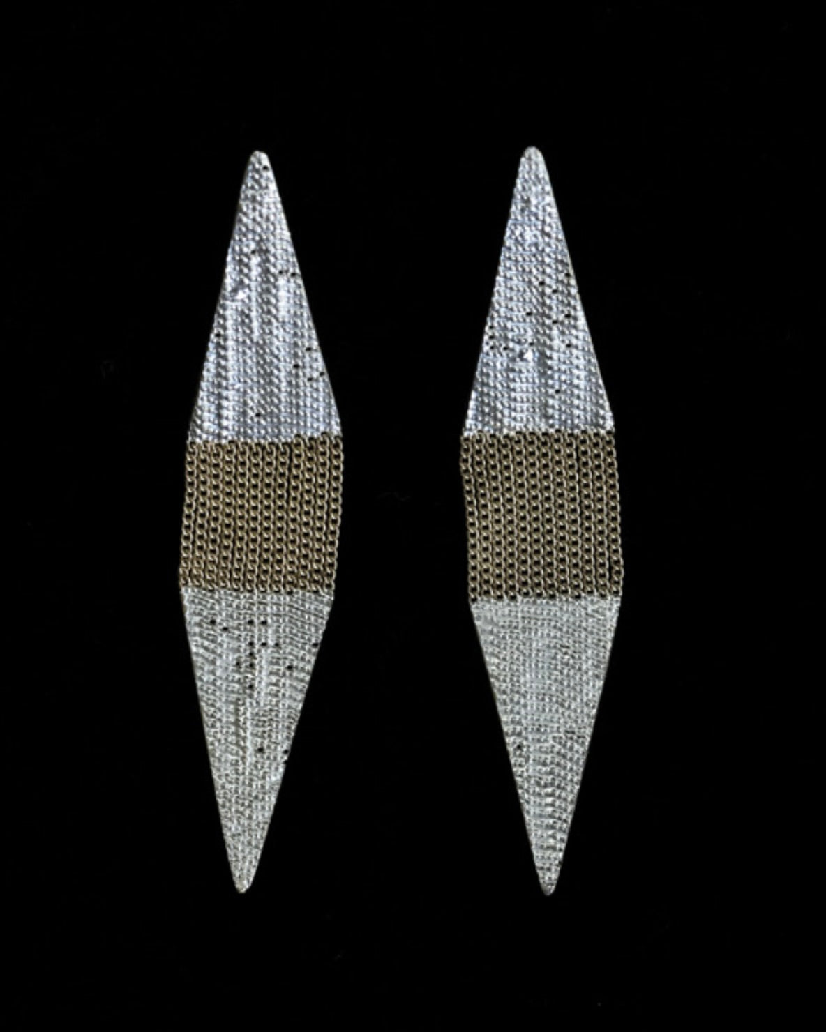 Image of diamond shaped sterling silver and brass chain earrings on a black background.