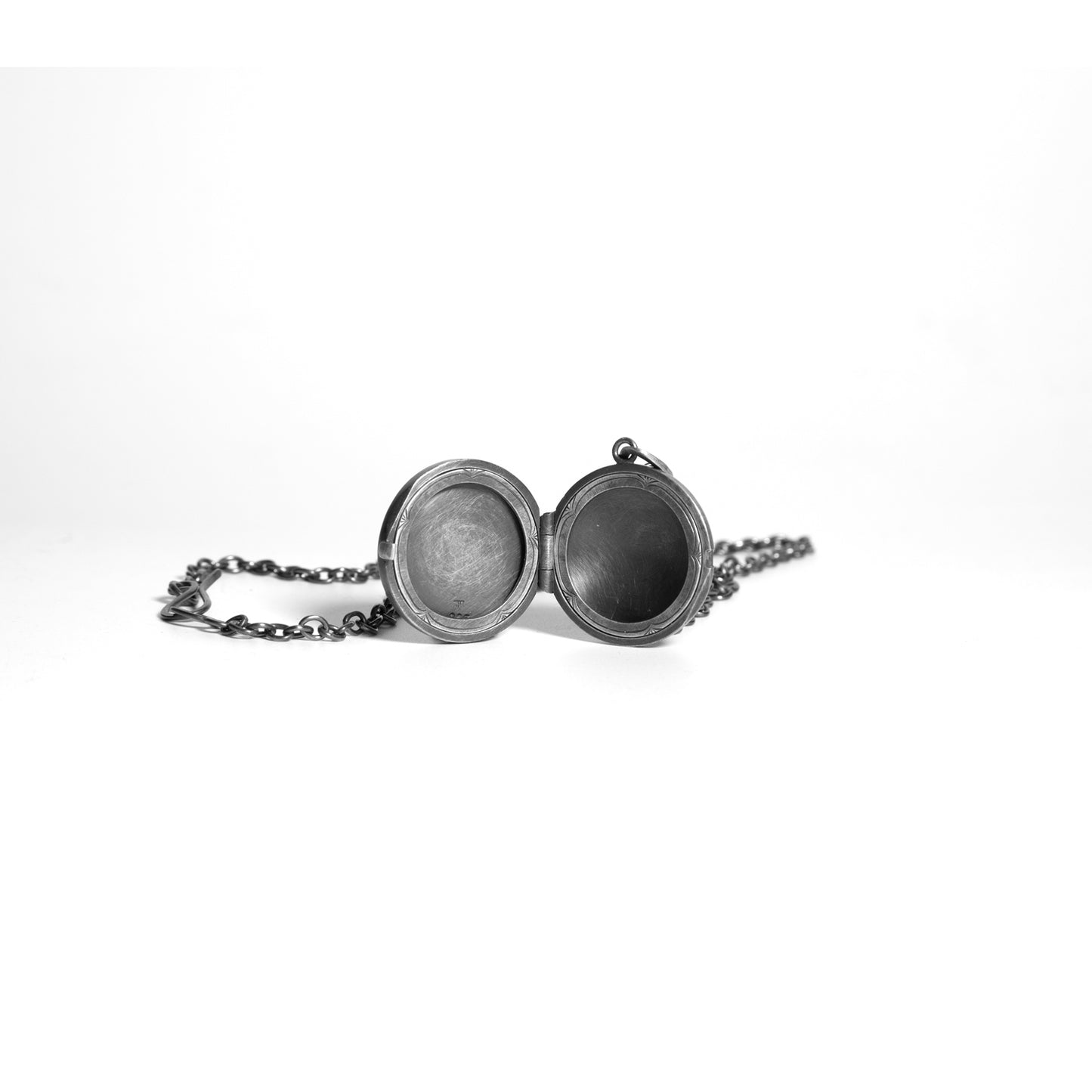 Silver locket with chain on a white background