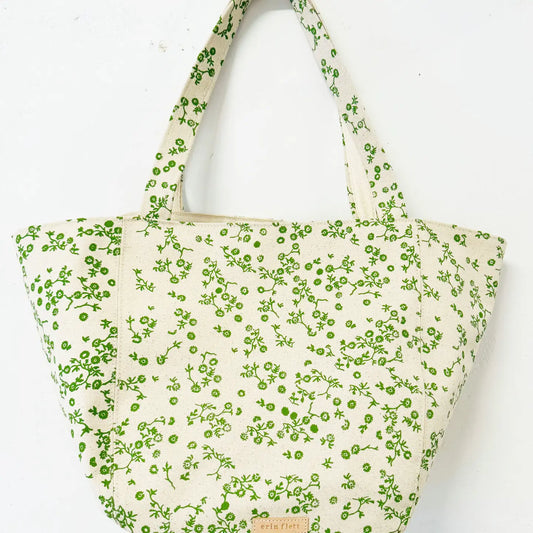 Tote bag with green floral pattern on a white background