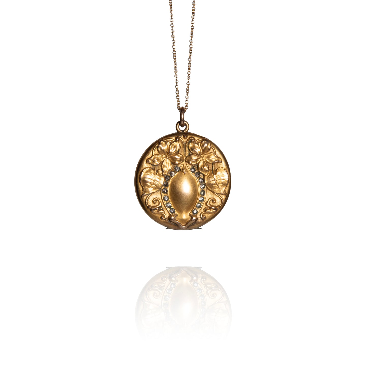 Gold necklace with a decorative pendant on a white background