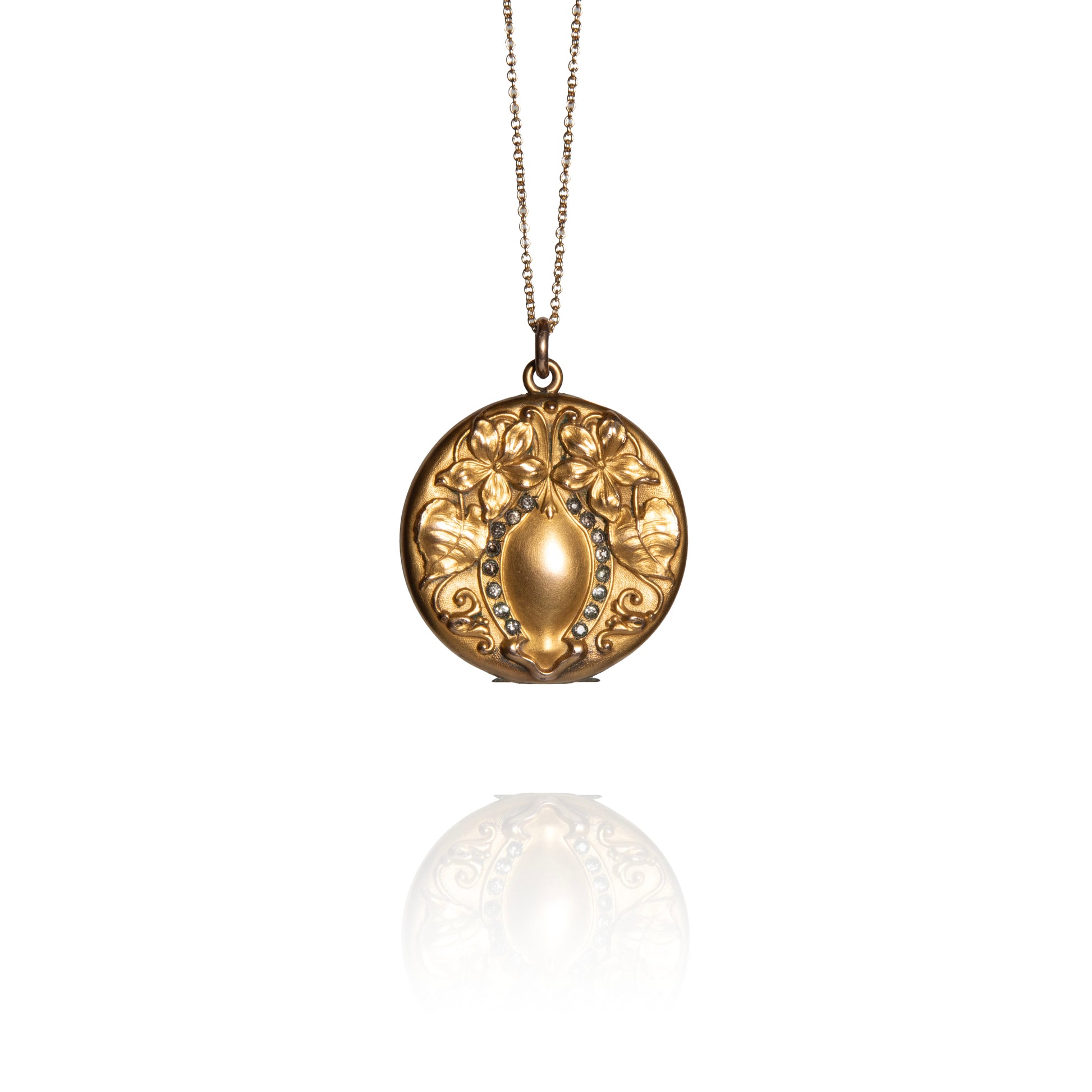 Gold necklace with a decorative pendant on a white background