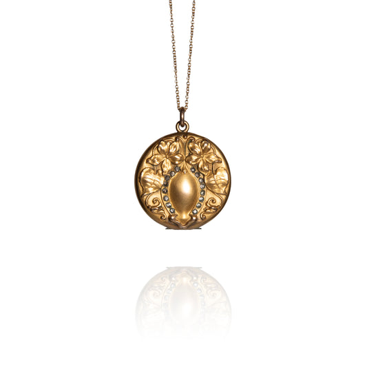 Gold necklace with a decorative pendant on a white background