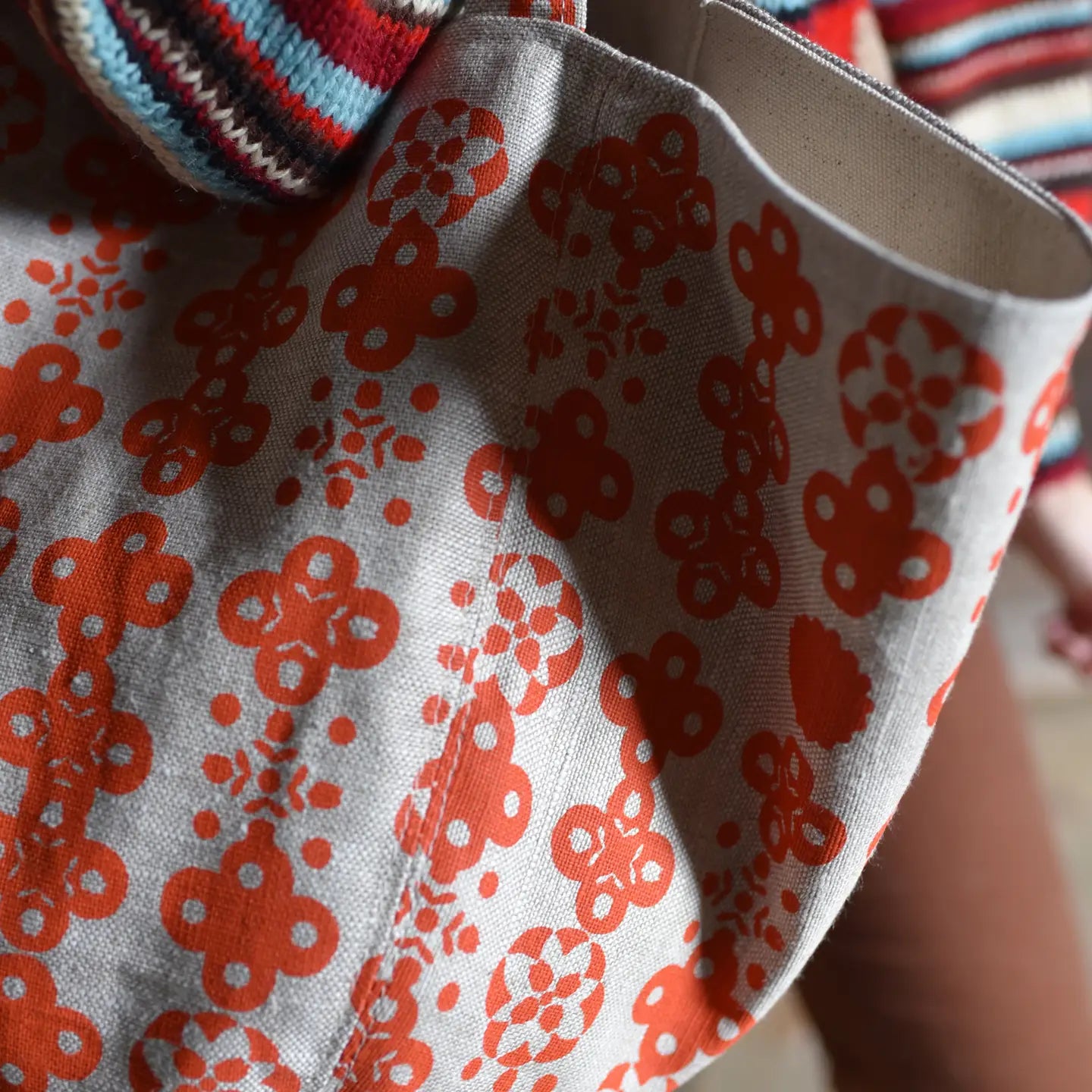 Close-up of a fabric with red floral pattern on gray background