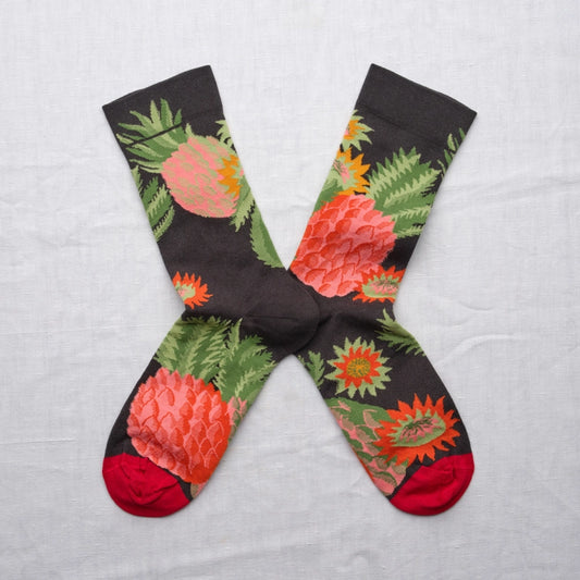 Colorful socks with floral design on a light gray background