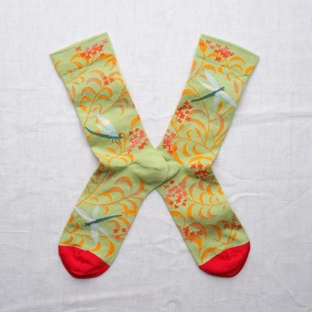Colorful socks with floral pattern on a light gray background