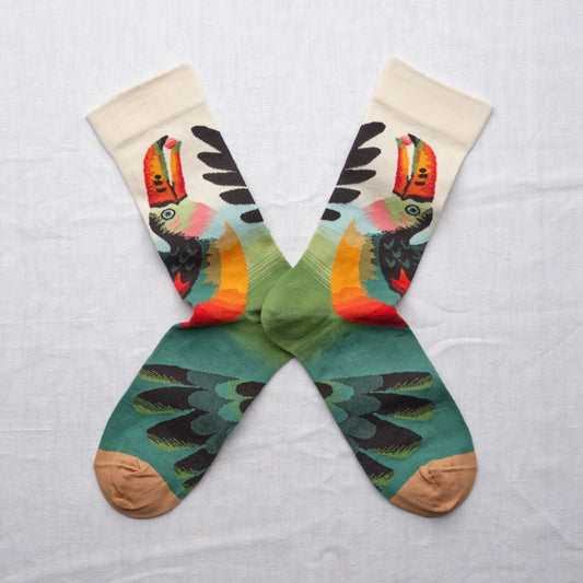 Colorful socks with toucan design on a light gray background