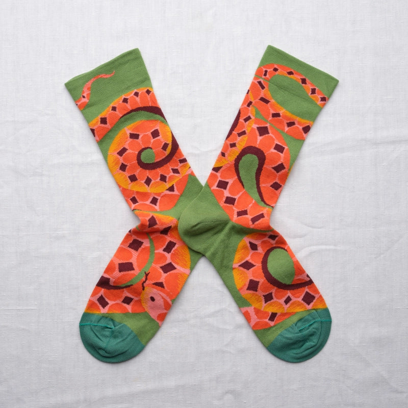 Colorful socks with snake pattern on a light gray background