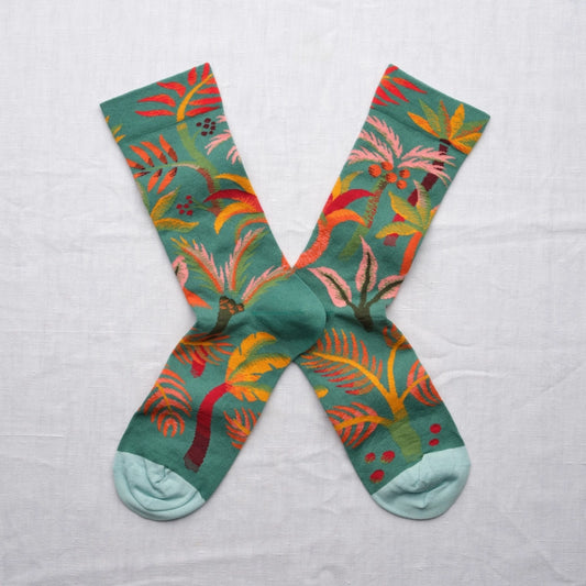 Colorful socks with leaf pattern on a light gray background