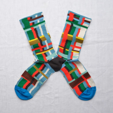 Colorful geometric patterned socks on a light gray background