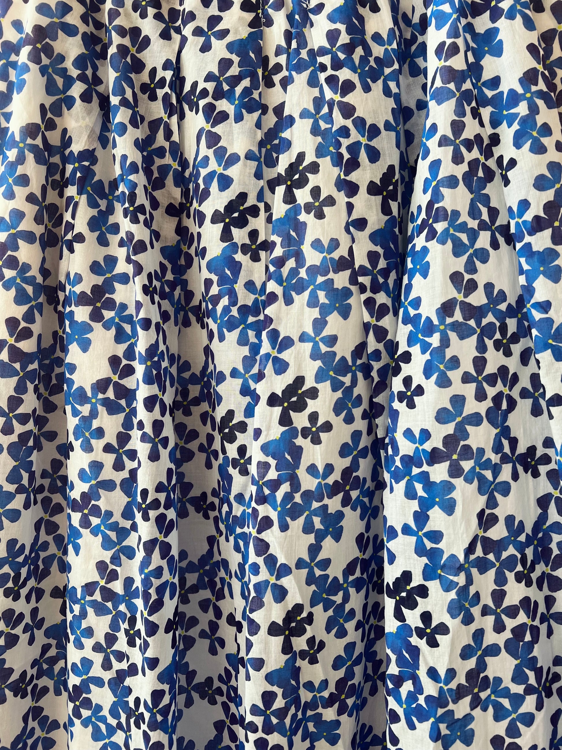 Floral patterned fabric with blue flowers on a beige background