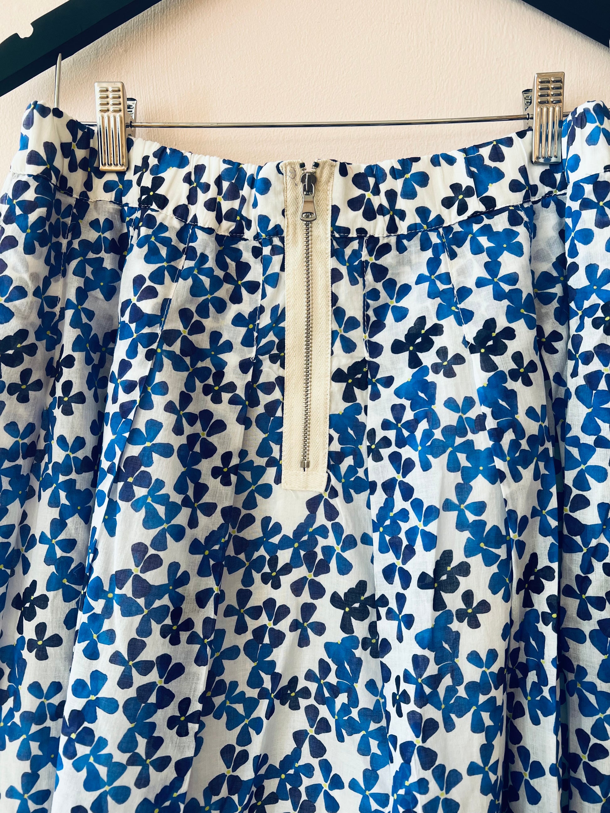 Blue floral patterned dress on a hanger