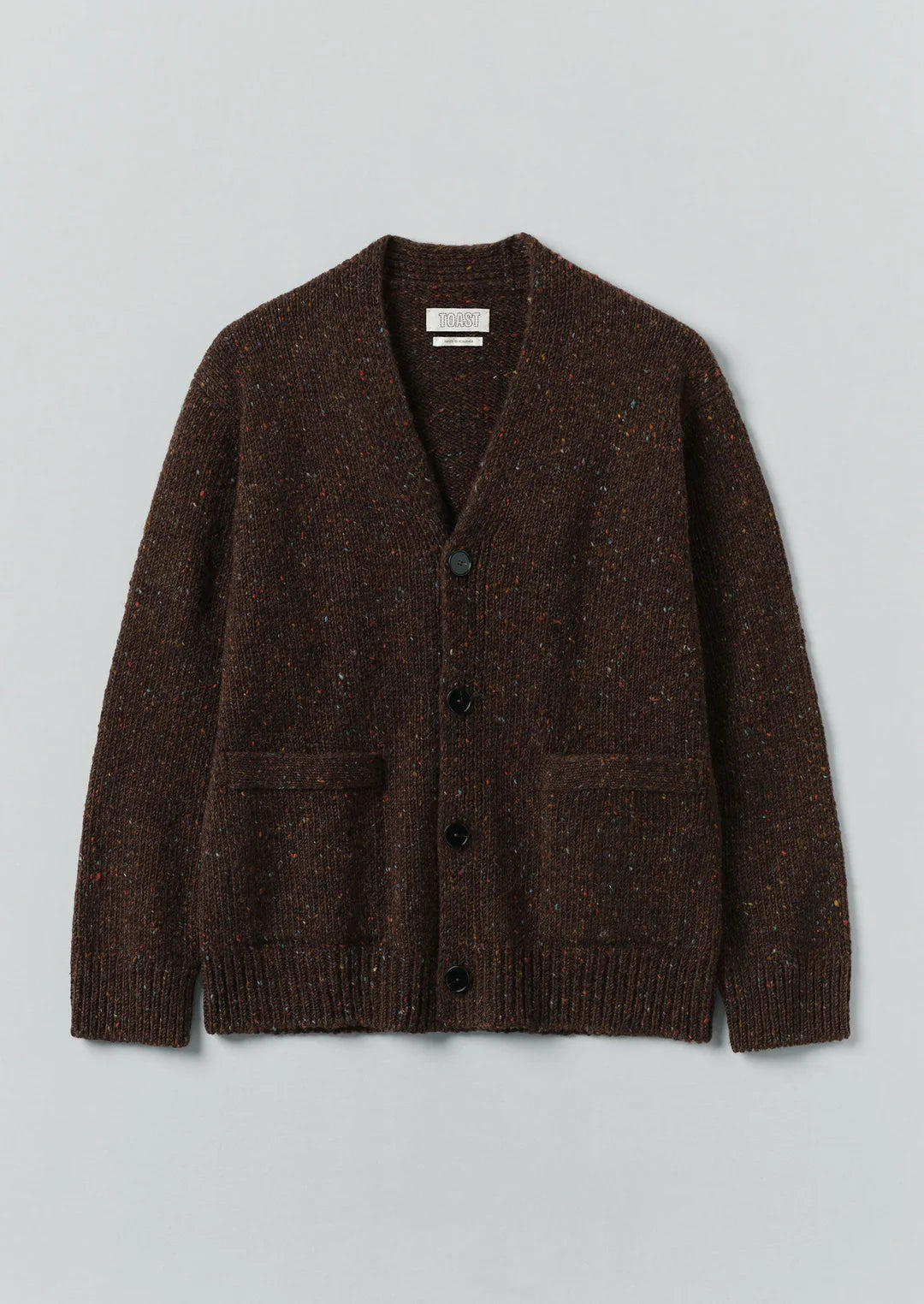 Brown knitted cardigan on a light gray background