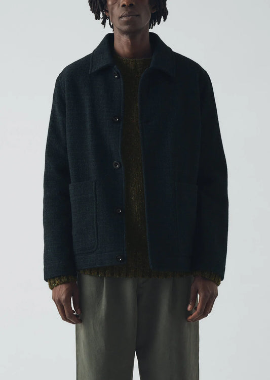 Person wearing a dark blue jacket on a white background