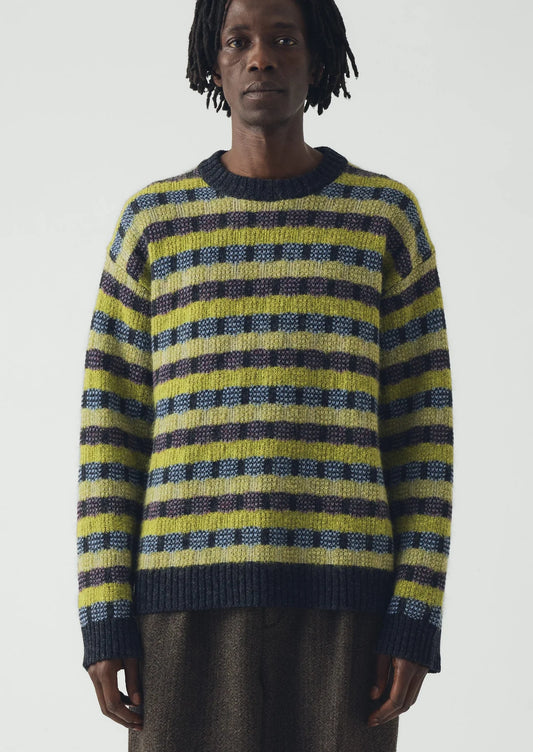 Image of man wearing a blue and green sweater