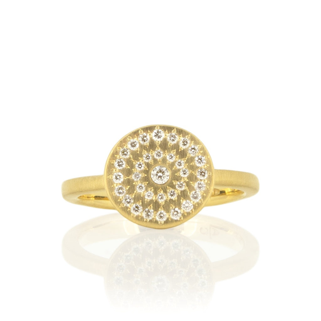 A gold ring with concentric circles of diamonds.